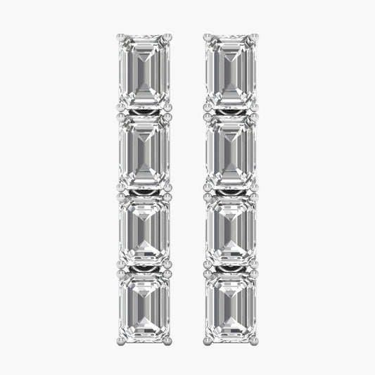 Pair of diamond earrings with emerald-cut stones on a white background