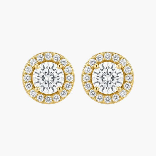 A pair of yellow gold stud earrings with a halo design, featuring a large round center stone surrounded by smaller round stones, set against a plain white background.