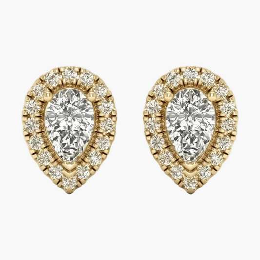 A pair of yellow gold teardrop-shaped stud earrings featuring pear-cut center stones surrounded by a halo of small round diamonds, set against a plain light gray background.