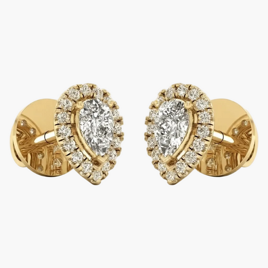A pair of yellow gold cufflinks featuring pear-cut diamonds surrounded by smaller round diamonds, set against a plain light gray background.