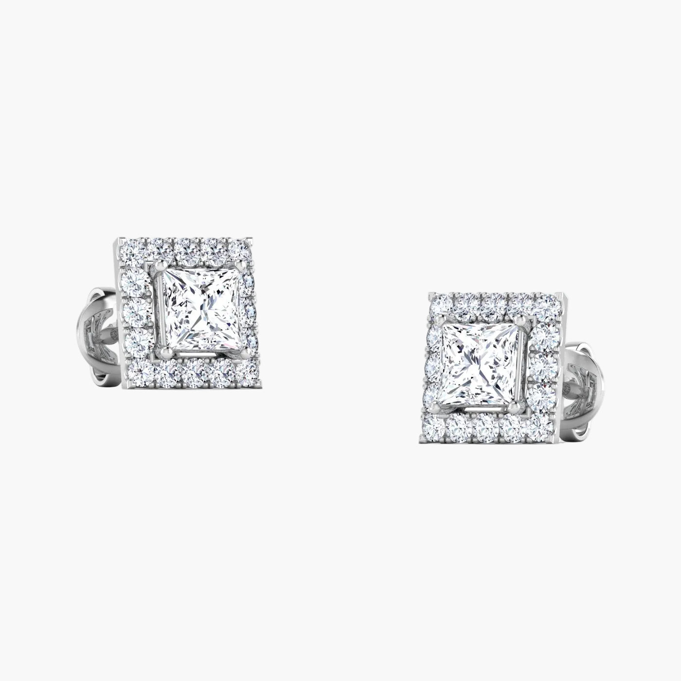 Pair of silver teardrop-shaped earrings with clear gemstones on a white background