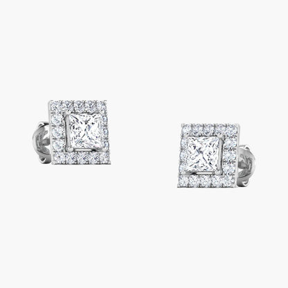 Pair of silver teardrop-shaped earrings with clear gemstones on a white background