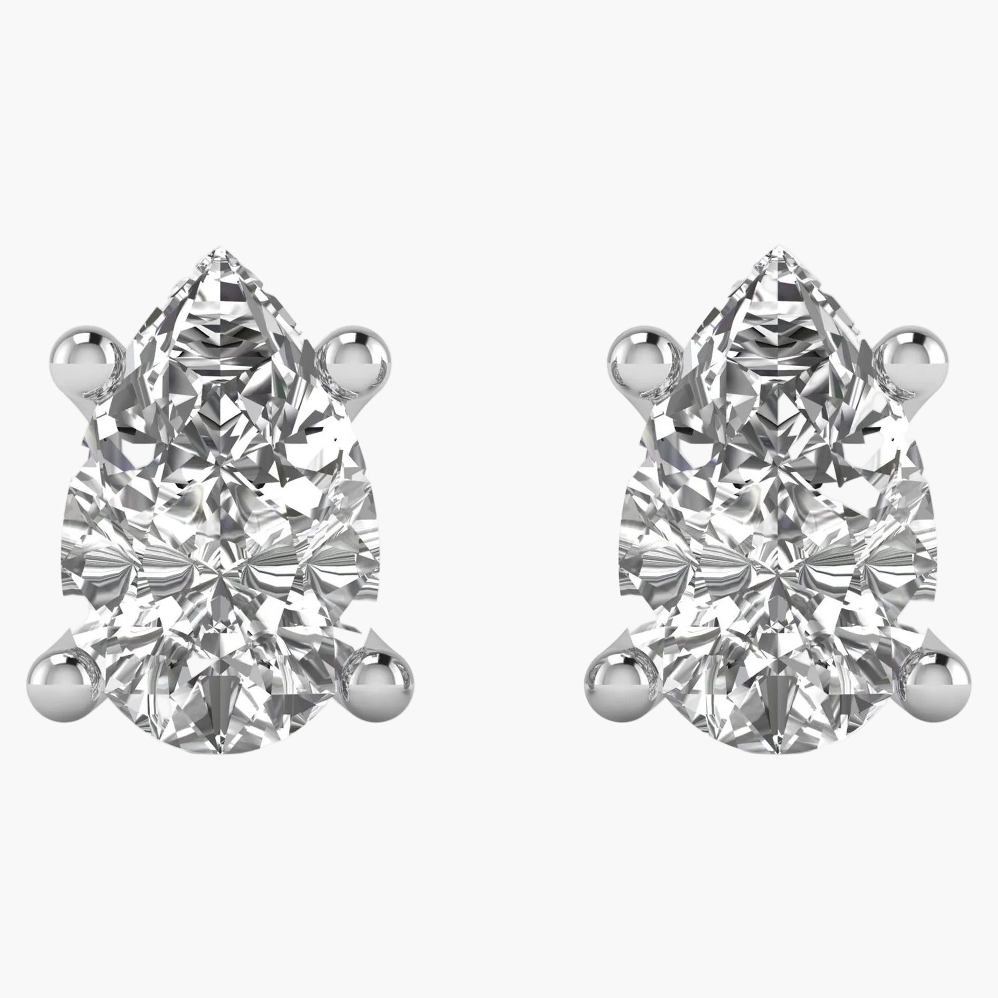 Pair of pear-shaped diamond stud earrings on a white background