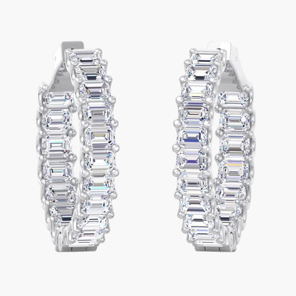 Pair of diamond hoop earrings on a white background