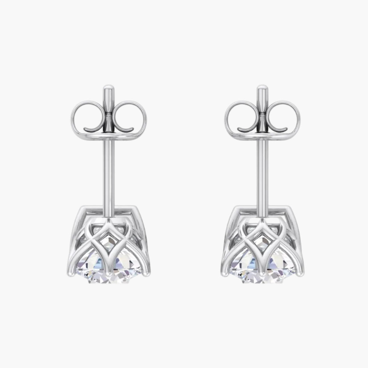 Pair of silver earrings with intricate designs on a white background