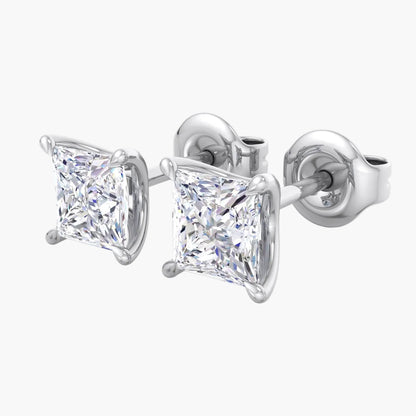 Pair of diamond stud earrings on a white background