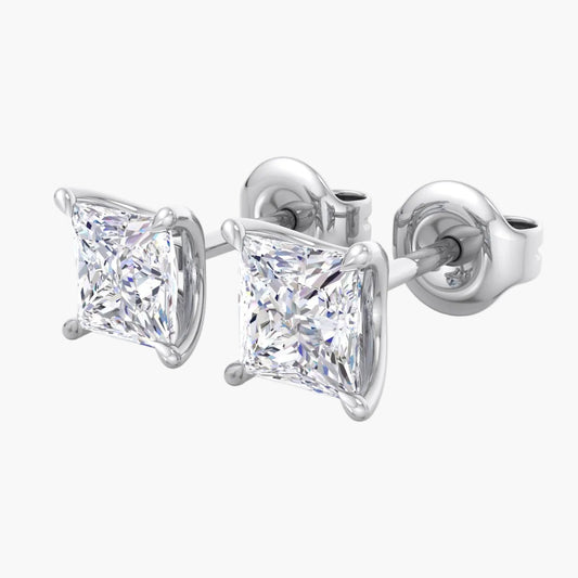 Pair of diamond stud earrings on a white background