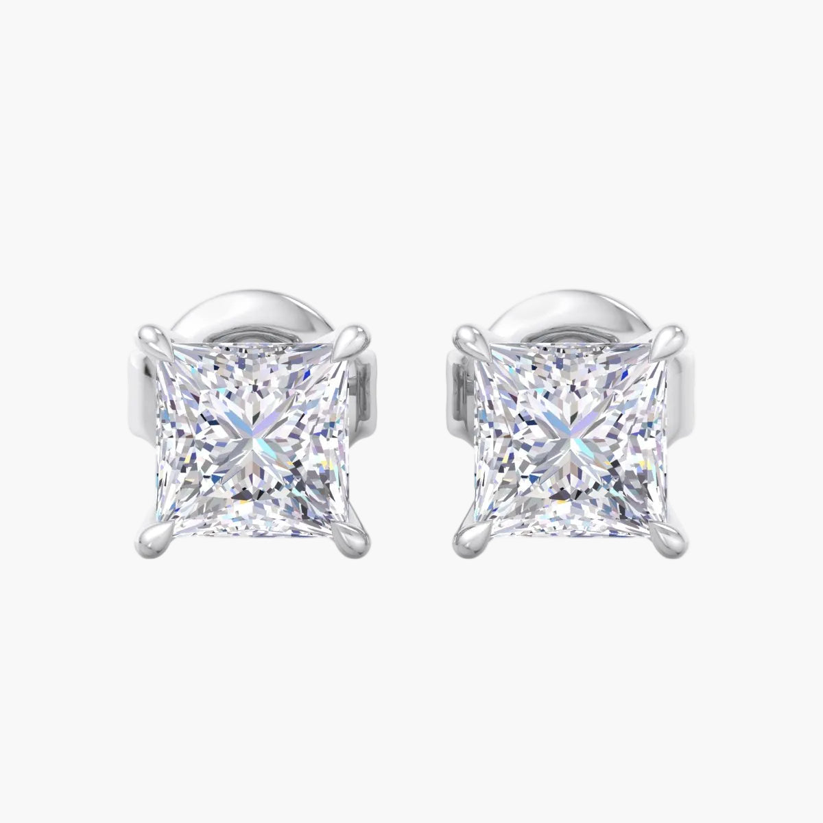 Pair of silver stud earrings with clear gemstones on a white background
