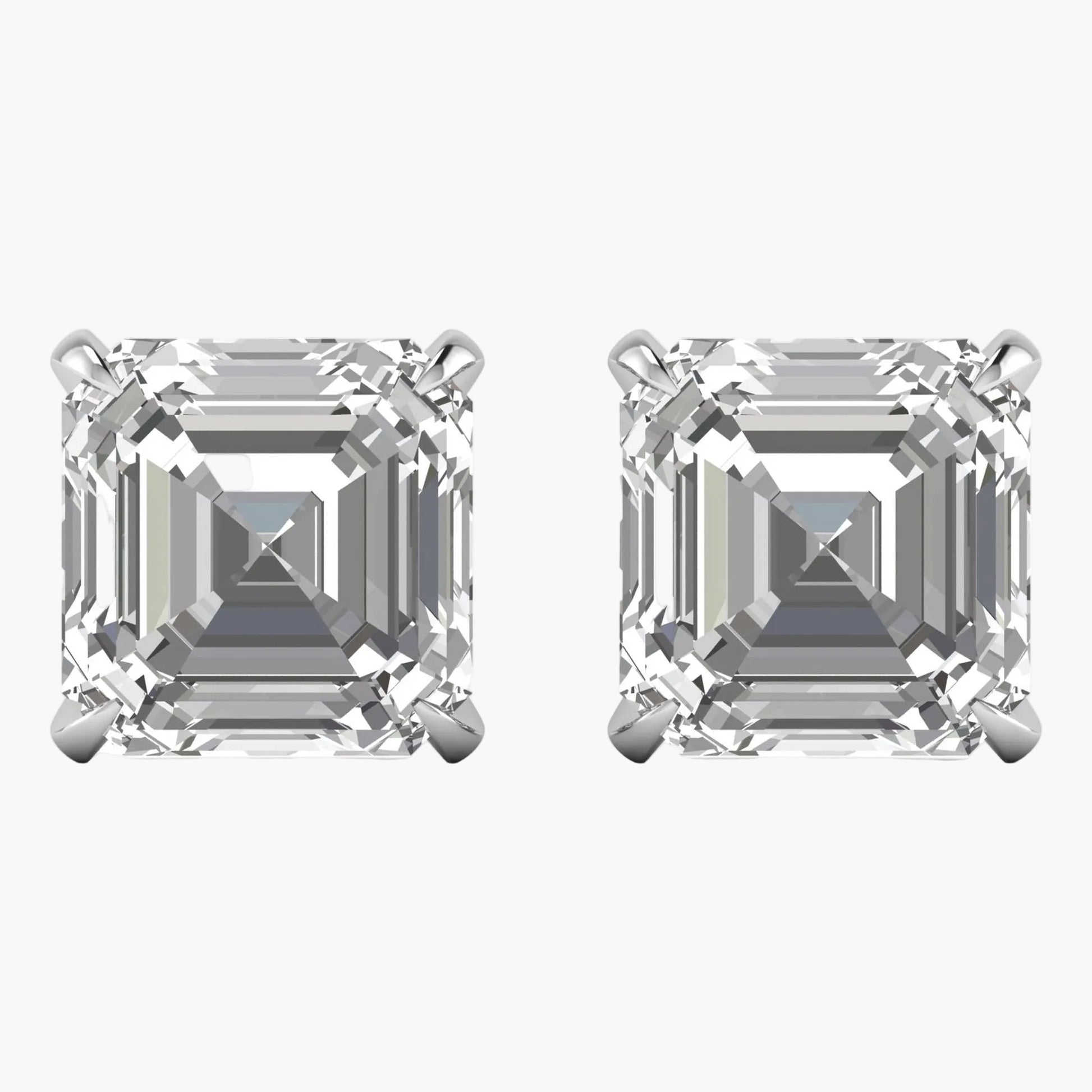 Pair of diamond stud earrings with asscher cut stones on a white background