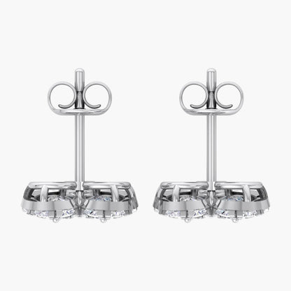 Pair of silver earrings with clear gemstones on a white background