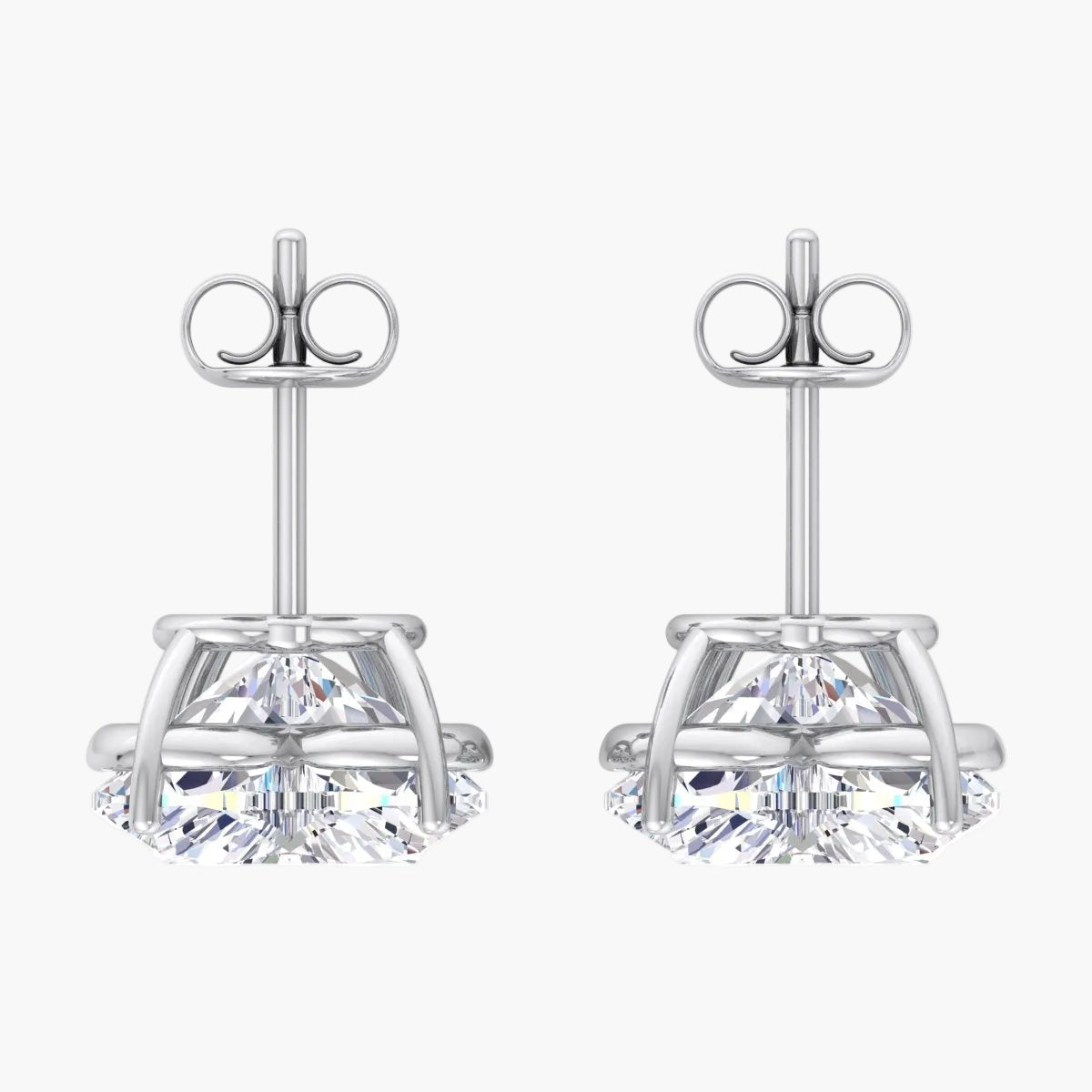 Pair of silver stud earrings with clear gemstones on a white background
