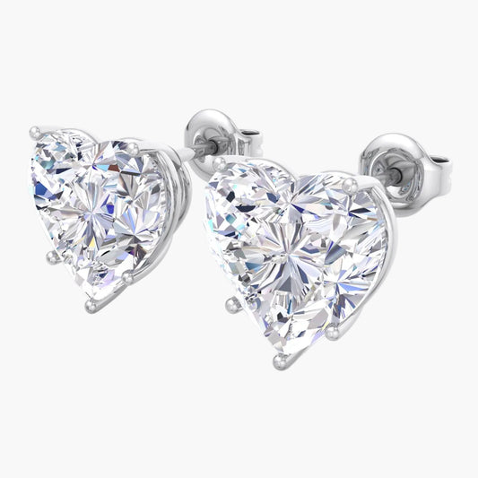 Heart-shaped diamond earrings on a white background