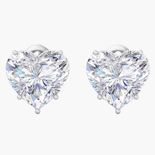 Heart-shaped diamond earrings on a white background