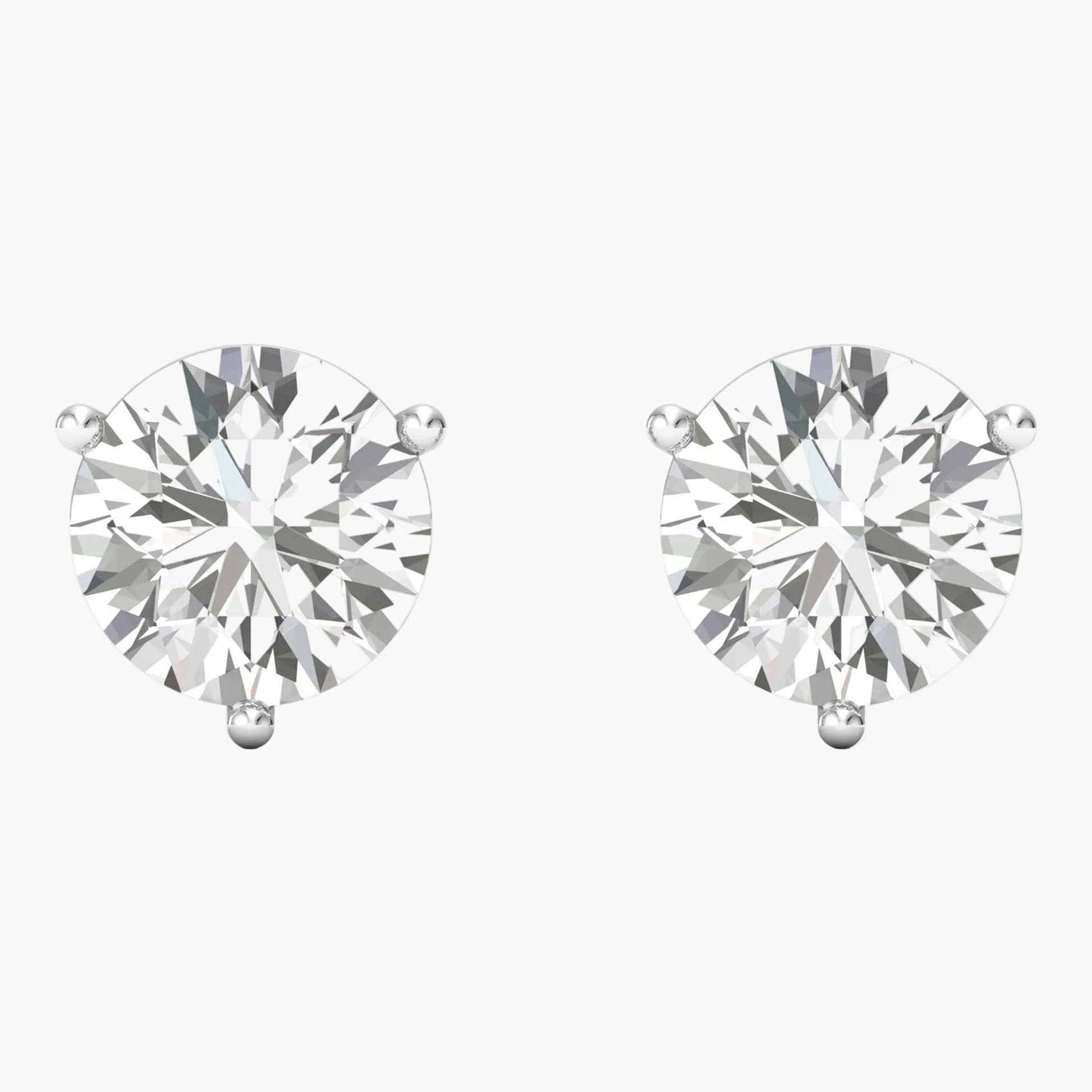 Pair of diamond stud earrings on a white background