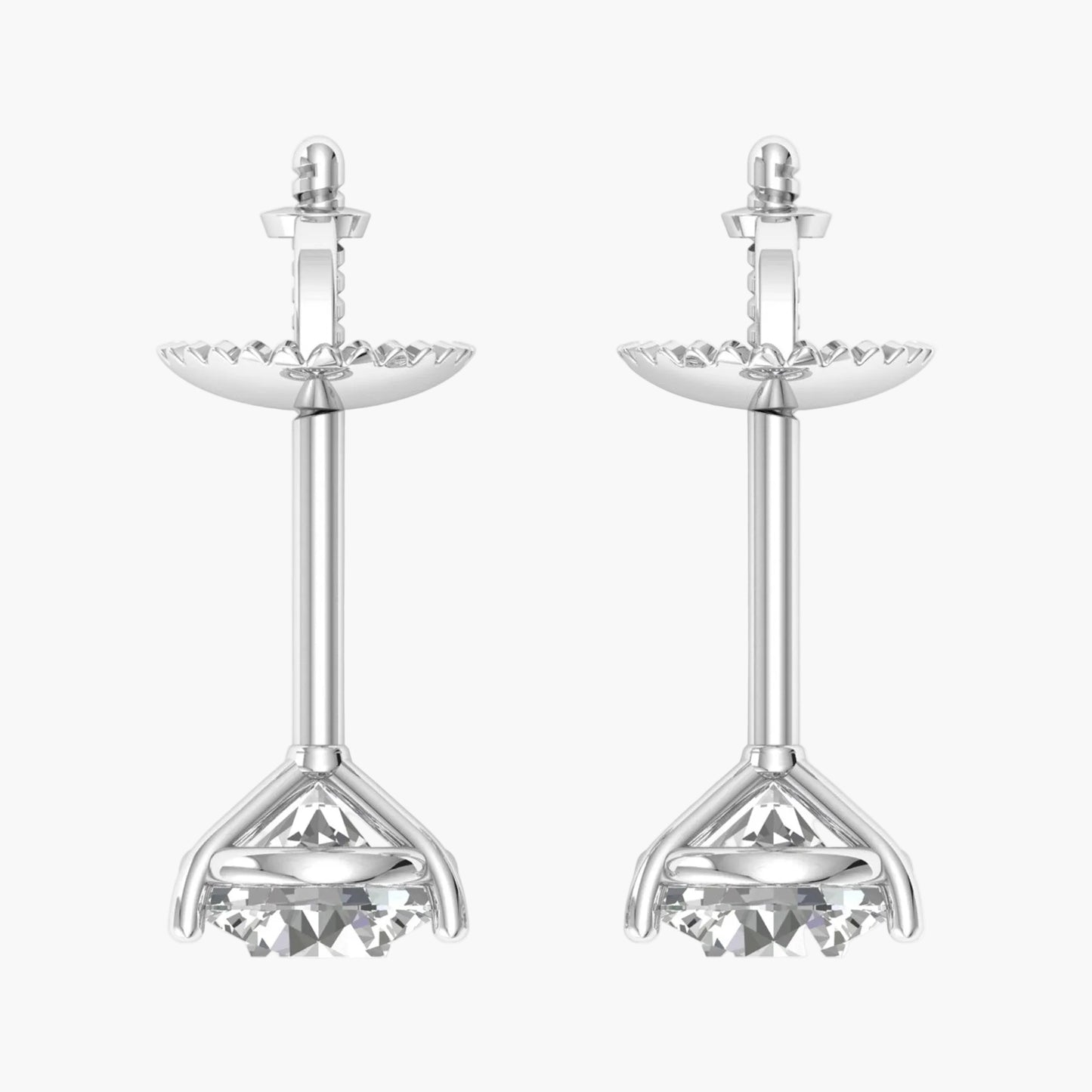 Pair of silver earrings with intricate designs on a white background