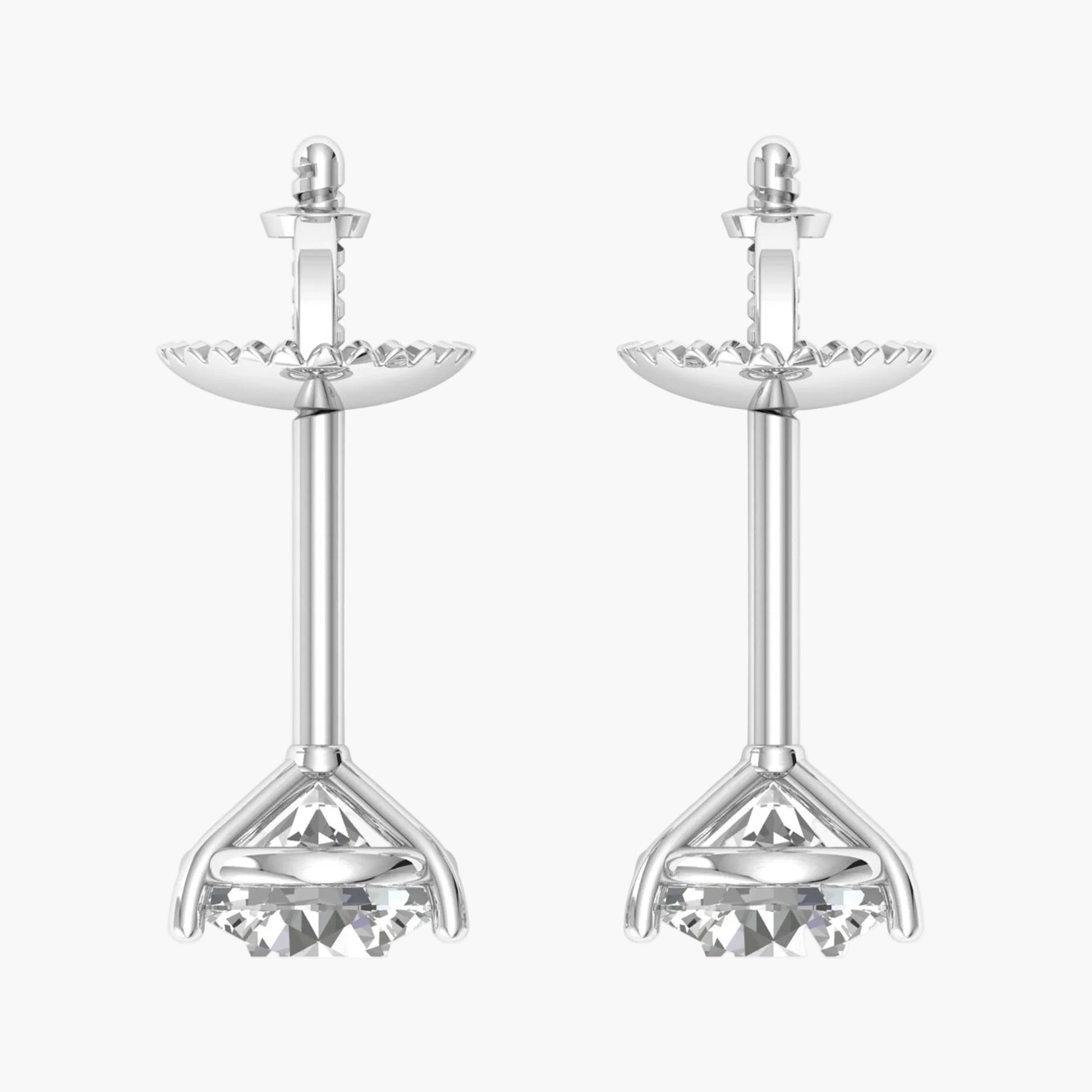 Pair of silver earrings with intricate designs on a white background