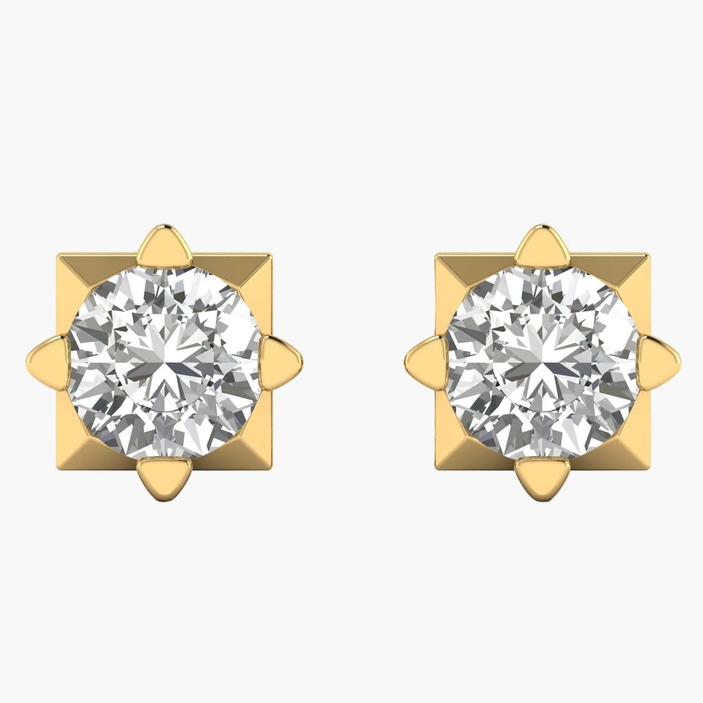 Pair of gold earrings with clear gemstones on a white background