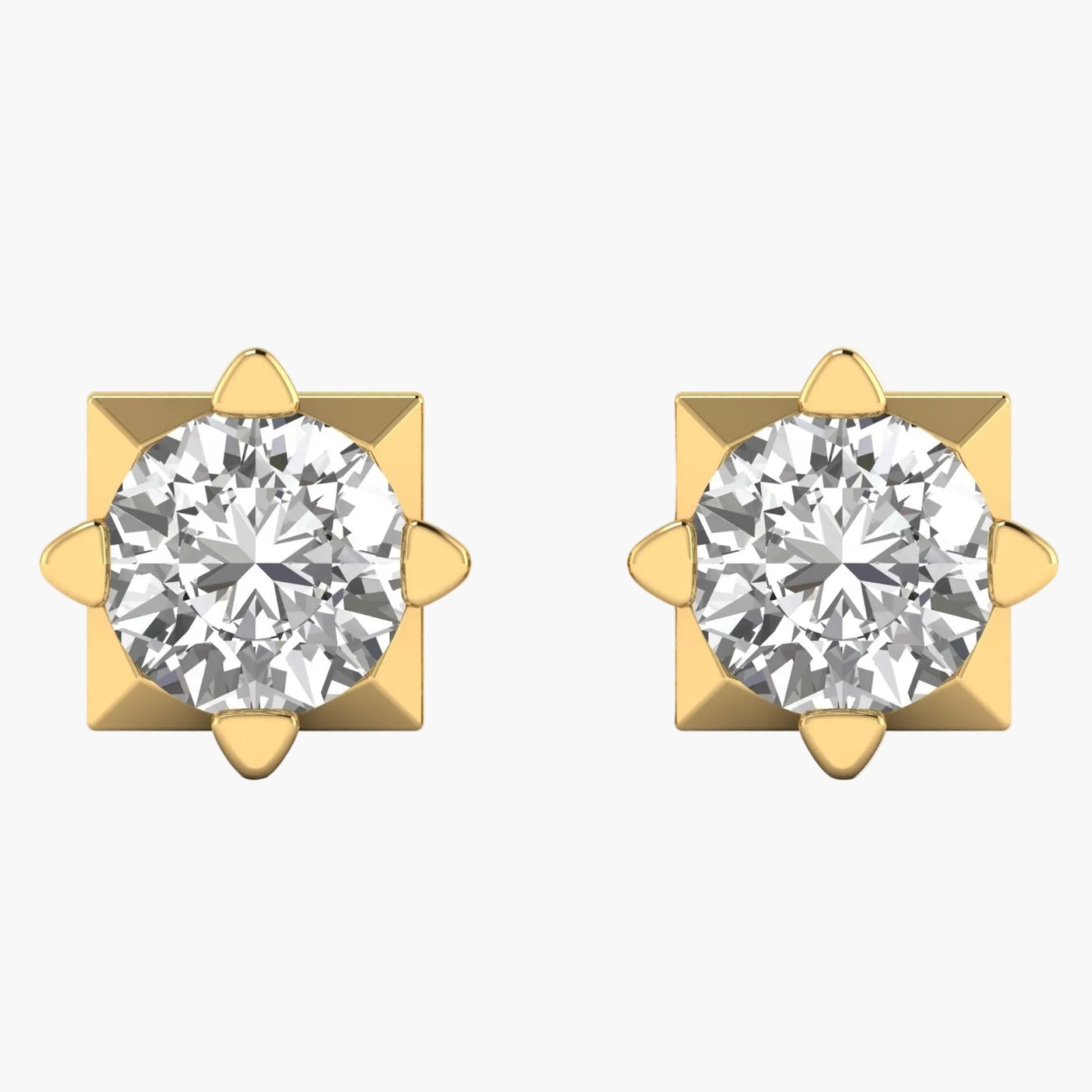 Pair of gold earrings with clear gemstones on a white background