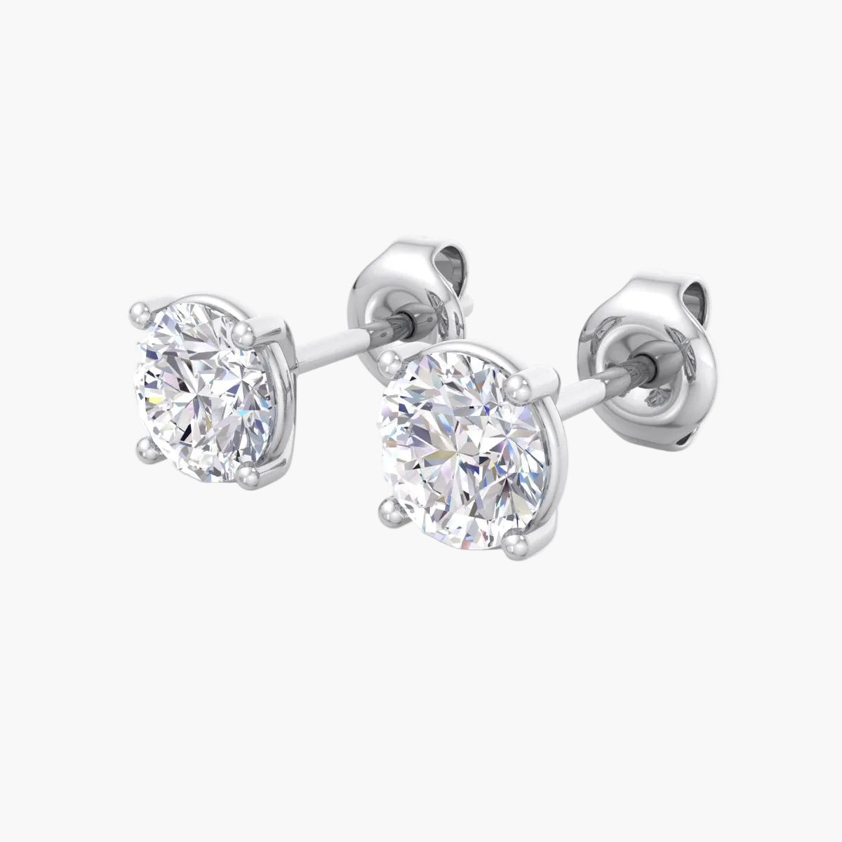 Pair of diamond stud earrings on a white background