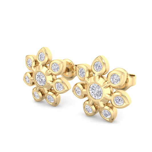 Gold earrings with diamond accents on a white background