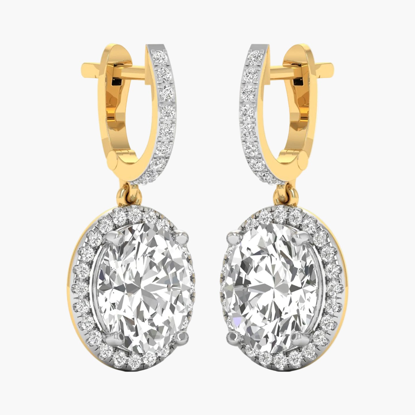 Gold hoop earrings with large clear gemstones on a white background