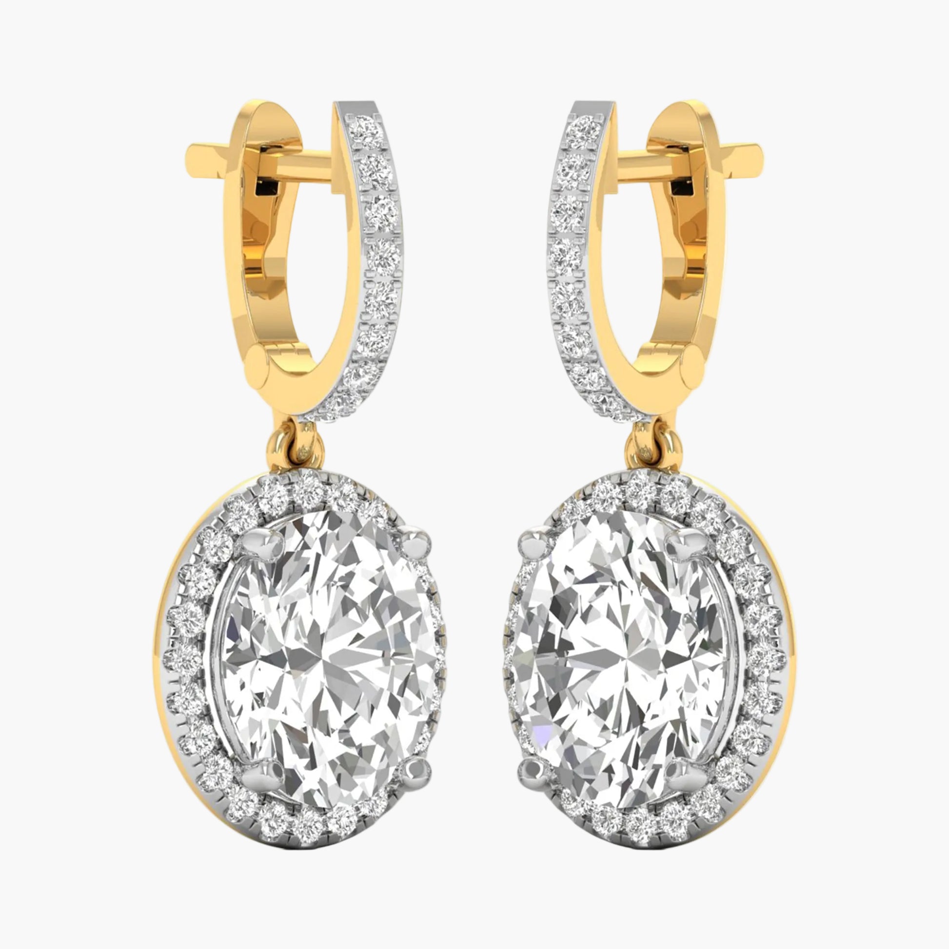 Gold hoop earrings with large clear gemstones on a white background