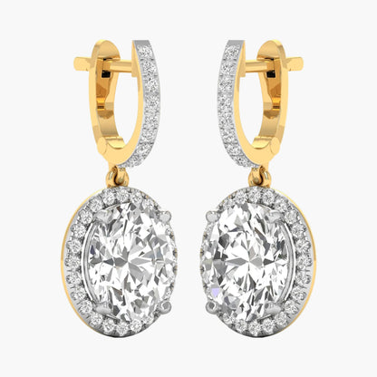 Gold hoop earrings with large clear gemstones on a white background