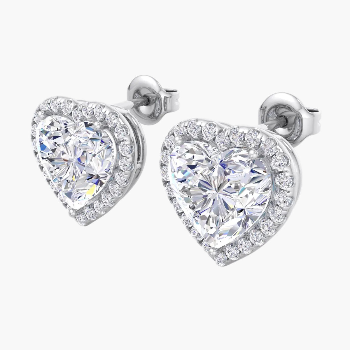 Heart-shaped diamond earrings on a white background