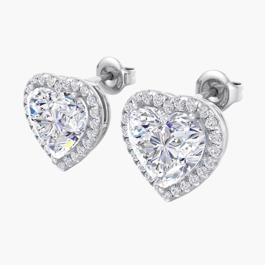 Heart-shaped diamond earrings on a white background