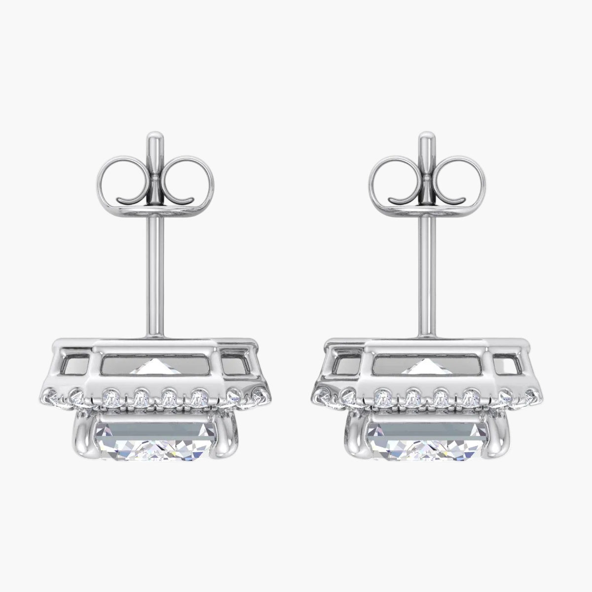 Pair of silver earrings with clear gemstones on a white background