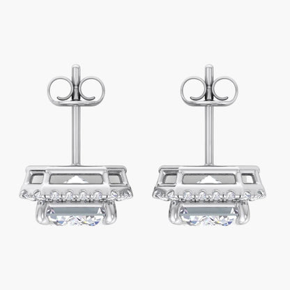 Pair of silver earrings with clear gemstones on a white background