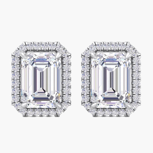 Pair of diamond earrings with emerald-cut gemstones on a white background