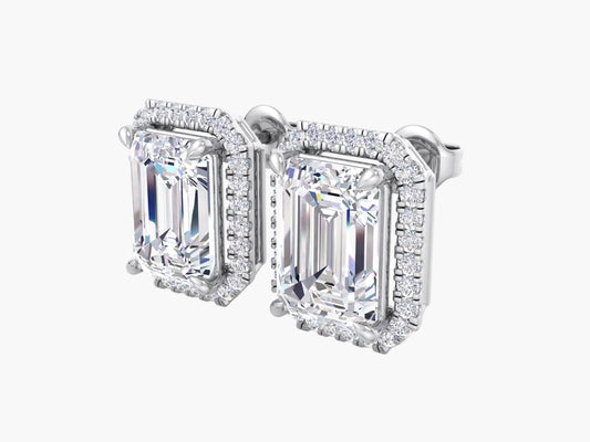 Diamond earrings with emerald-cut stones on a white background