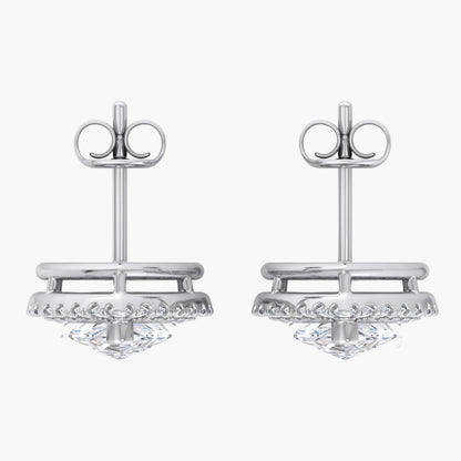 Pair of silver earrings with intricate designs on a white background
