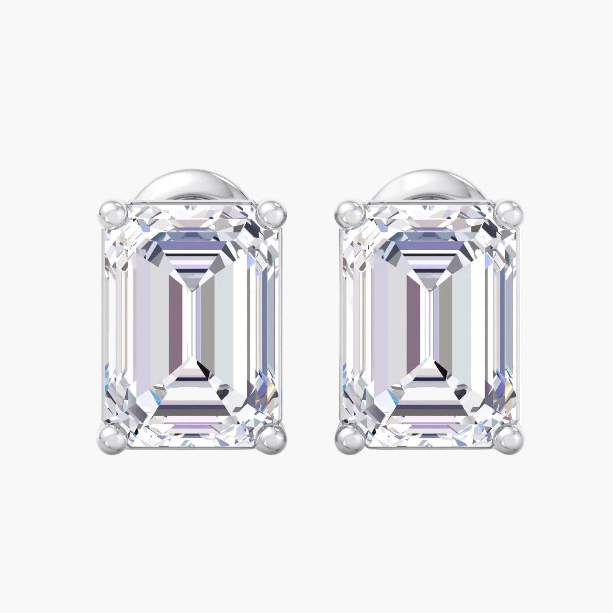 Pair of emerald-cut diamond earrings on a white background
