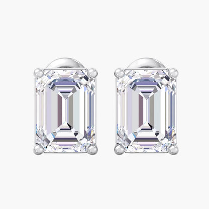 Pair of emerald-cut diamond earrings on a white background