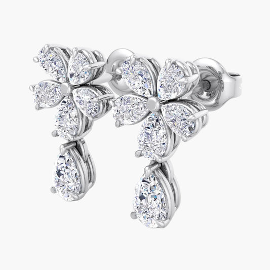 Silver earrings with diamond-like stones on a white background