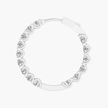 Silver hoop earring with heart-shaped gemstones on a white background