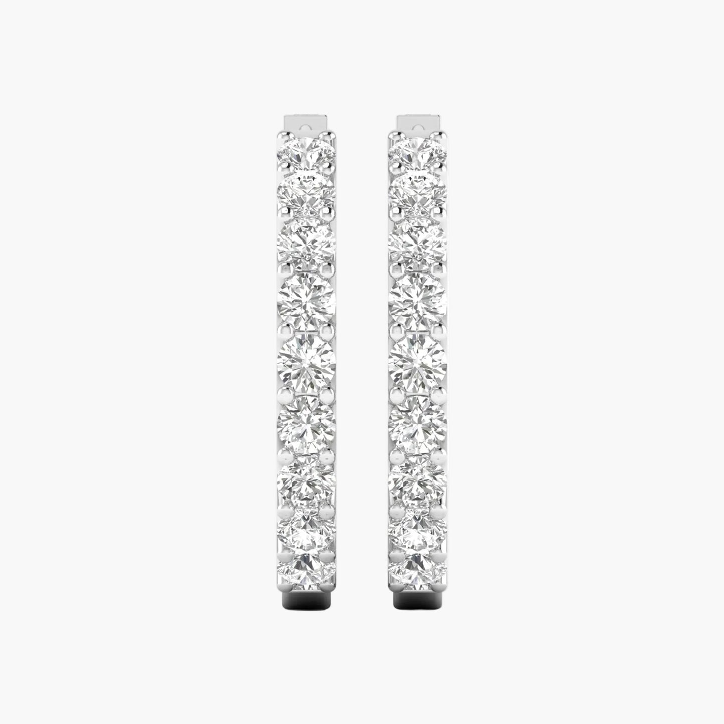 Pair of diamond hoop earrings on a white background