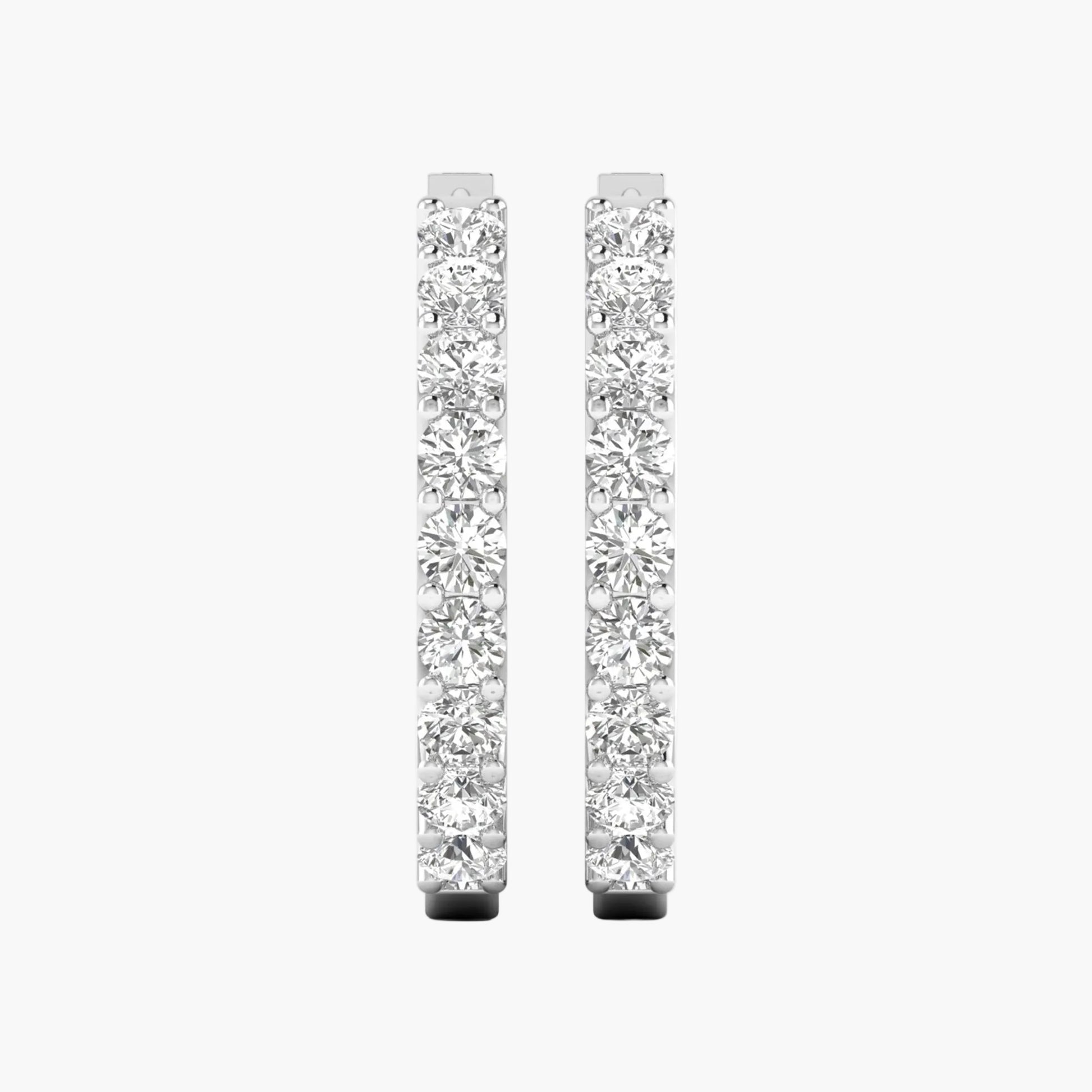 Pair of diamond hoop earrings on a white background