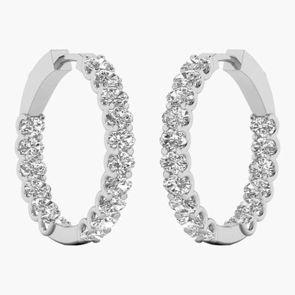 Pair of silver hoop earrings with clear gemstones on a white background