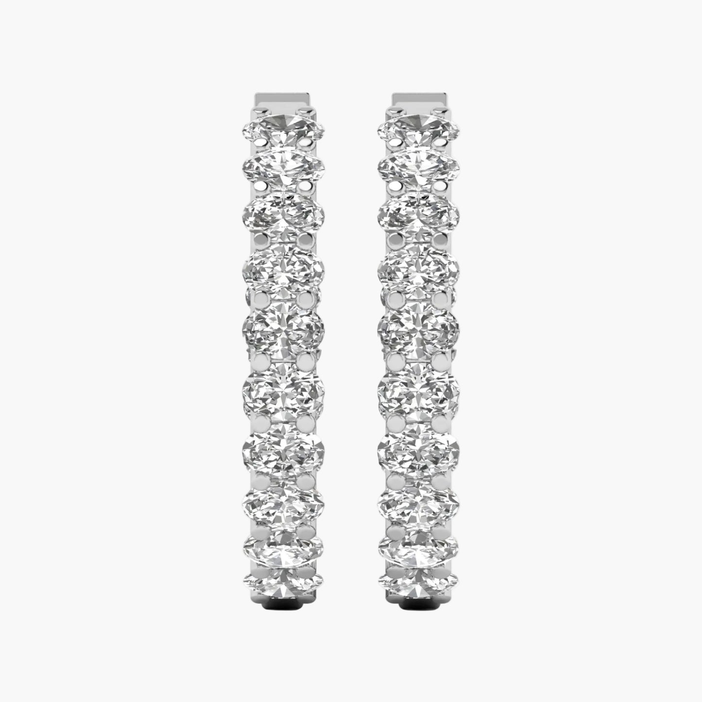 Pair of diamond hoop earrings on a white background