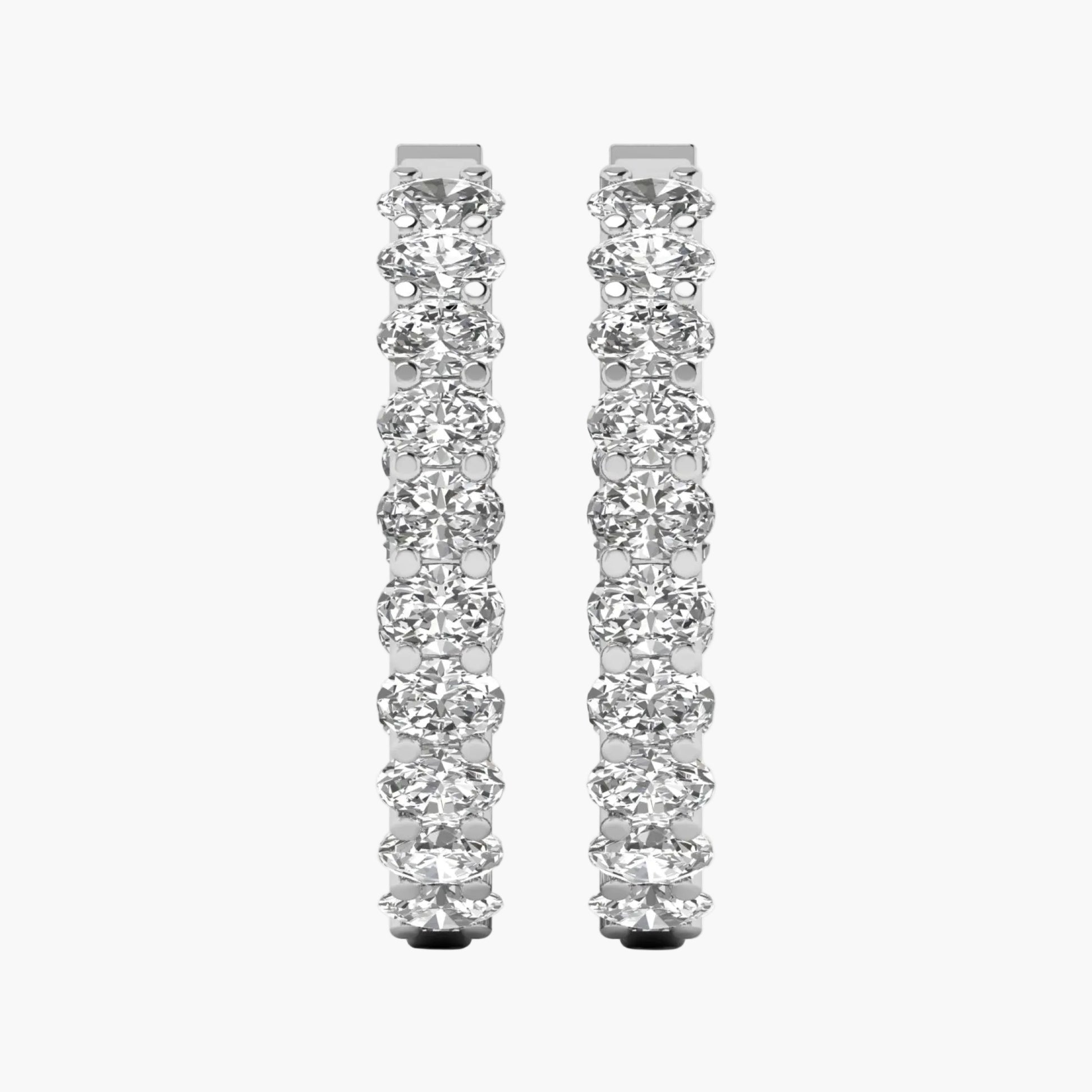Pair of diamond hoop earrings on a white background