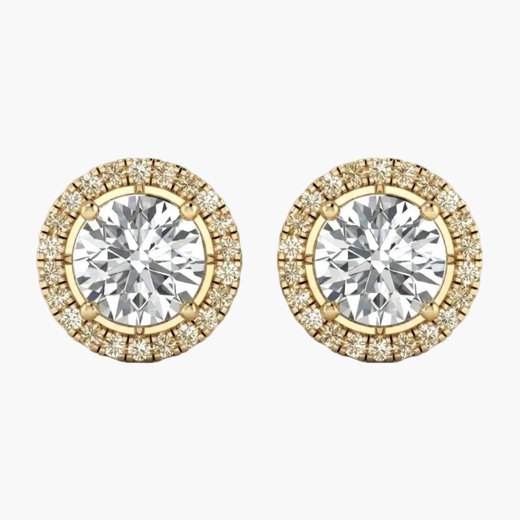 A pair of yellow gold stud earrings featuring a large round brilliant-cut center stone surrounded by a halo of smaller diamonds, shown on a plain white background.