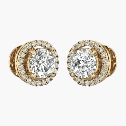 A pair of yellow gold stud earrings featuring a large round brilliant-cut center stone surrounded by a halo of smaller diamonds, shown on a clean white background.