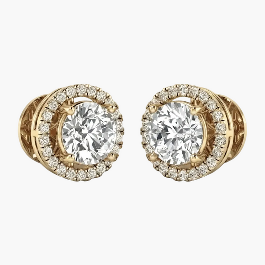 A pair of yellow gold stud earrings featuring a large round brilliant-cut center stone surrounded by a halo of smaller diamonds, shown on a clean white background.