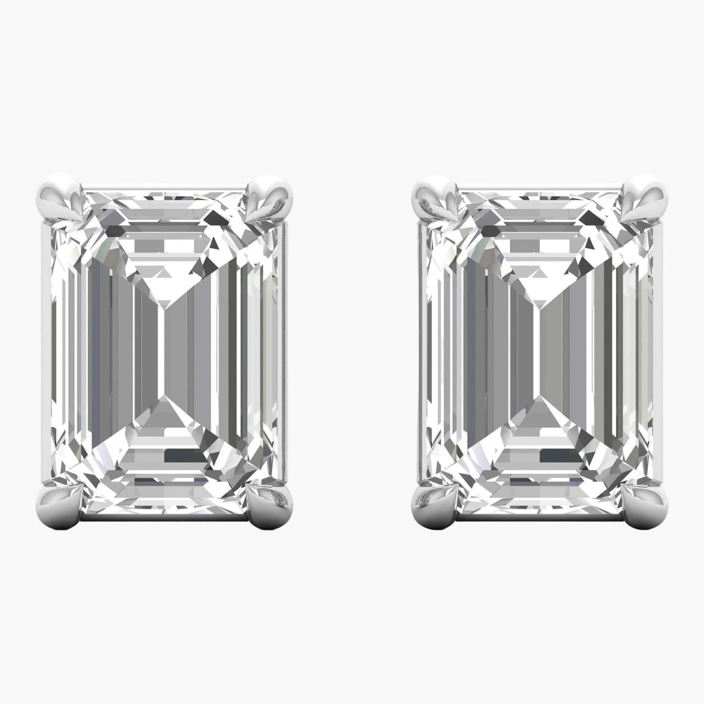 Pair of emerald-cut diamond earrings on a white background