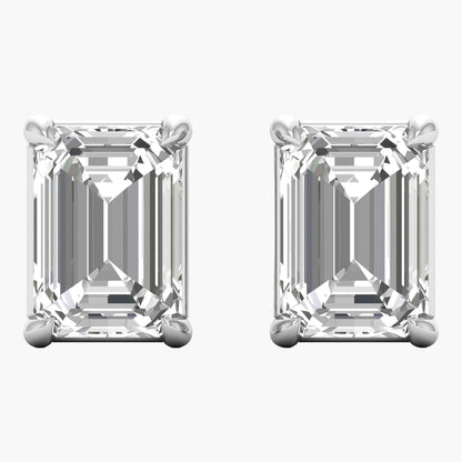 Pair of emerald-cut diamond earrings on a white background