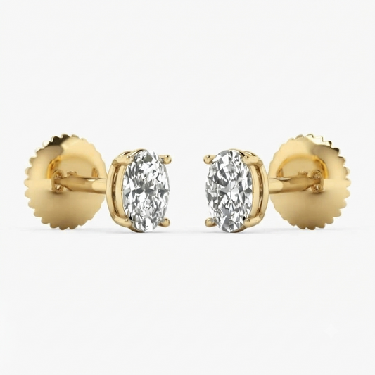 A pair of yellow gold oval stud earrings with marquise-cut clear gemstones, shown against a clean white background.