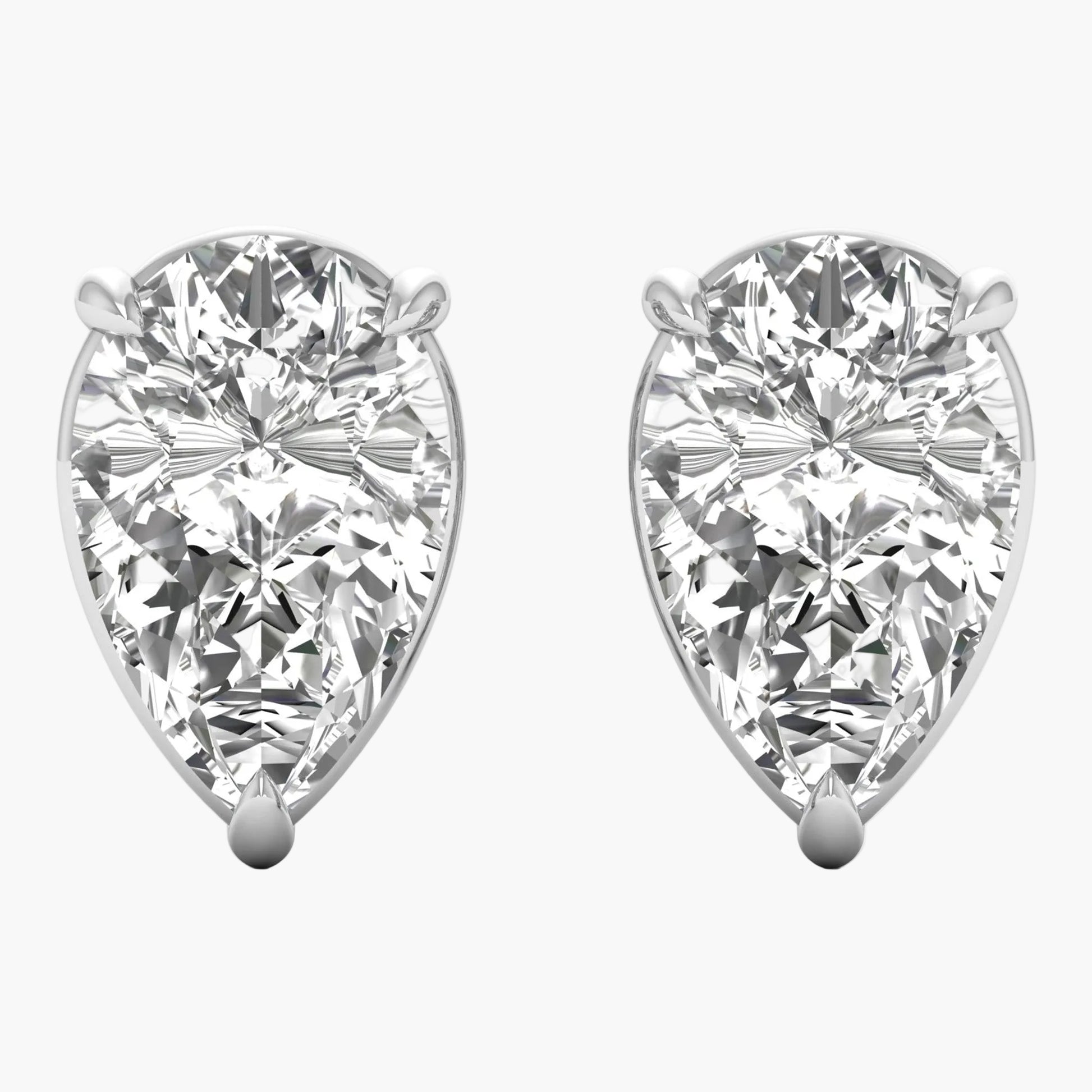 Pair of pear-shaped diamond earrings on a white background
